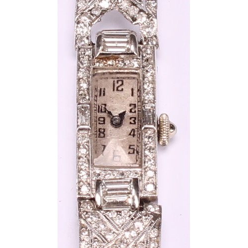 960 - An Art Deco diamond set platinum cocktail watch, the rectangular silvered dial with Arabic numerals,... 