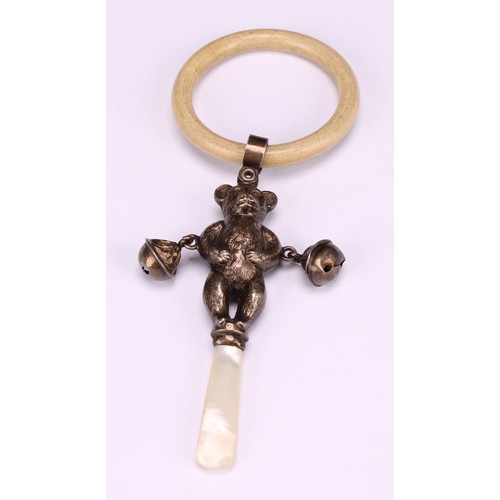 663 - A George V silver novelty baby's rattle, as a teddy bear, mother of pearl haft, ivorine teething rin... 