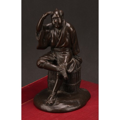 278 - Japanese School (Meiji period) a brown patinated bronze, a fisherman sitting on a basket, 17.5cm hig... 