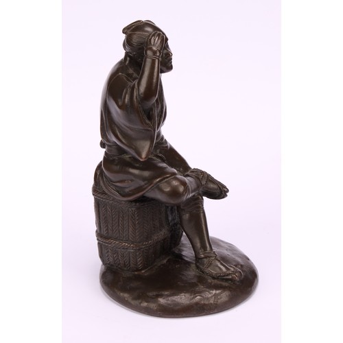 278 - Japanese School (Meiji period) a brown patinated bronze, a fisherman sitting on a basket, 17.5cm hig... 