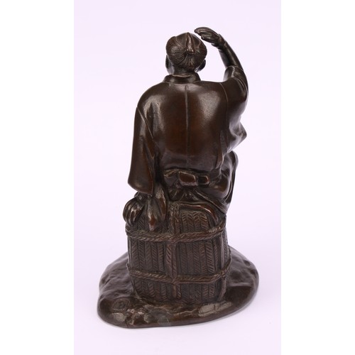 278 - Japanese School (Meiji period) a brown patinated bronze, a fisherman sitting on a basket, 17.5cm hig... 