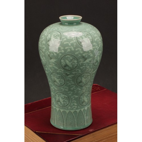 243 - A Korean celadon maebyeong vase, decorated with cranes within roundels on a crackle glazed ground, 2... 