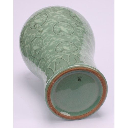 243 - A Korean celadon maebyeong vase, decorated with cranes within roundels on a crackle glazed ground, 2... 