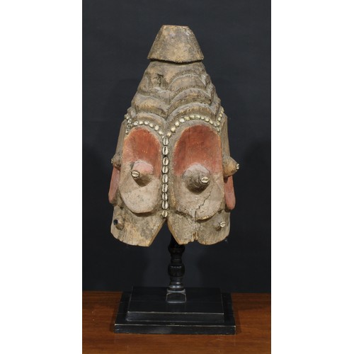 1373 - Tribal Art - a Bembe janus helmet mask, stylised features picked out with cowrie shells and decorate... 