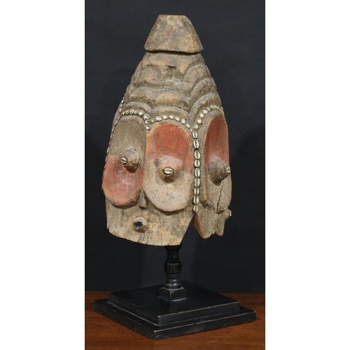 1373 - Tribal Art - a Bembe janus helmet mask, stylised features picked out with cowrie shells and decorate... 