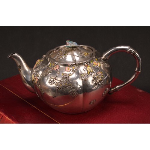 679 - A Japanese silver and enamel melon shaped teapot, decorated in polychrome with blossoming prunus, bu... 