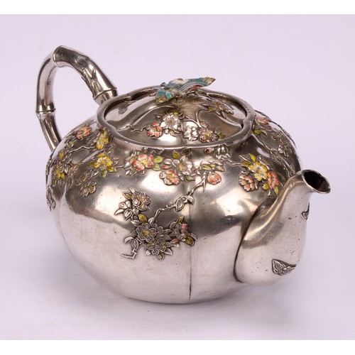 679 - A Japanese silver and enamel melon shaped teapot, decorated in polychrome with blossoming prunus, bu... 