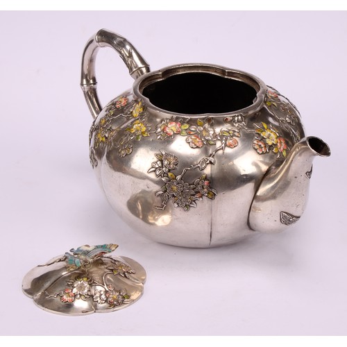 679 - A Japanese silver and enamel melon shaped teapot, decorated in polychrome with blossoming prunus, bu... 