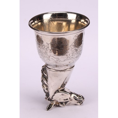 675 - A German silver novelty stirrup cup, as a horse's head, the ogee bowl engraved with a hunting scene,... 