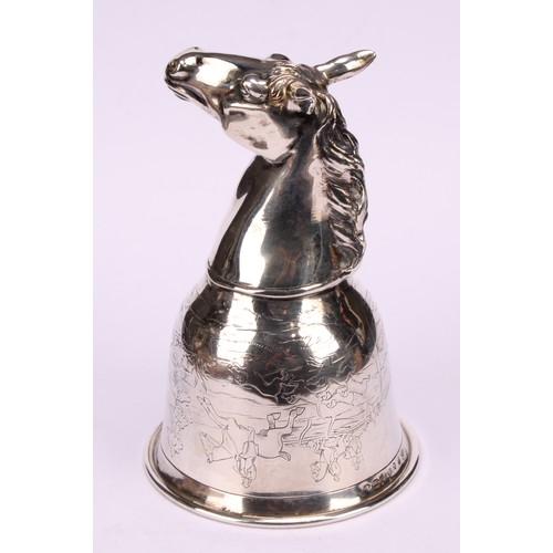 675 - A German silver novelty stirrup cup, as a horse's head, the ogee bowl engraved with a hunting scene,... 