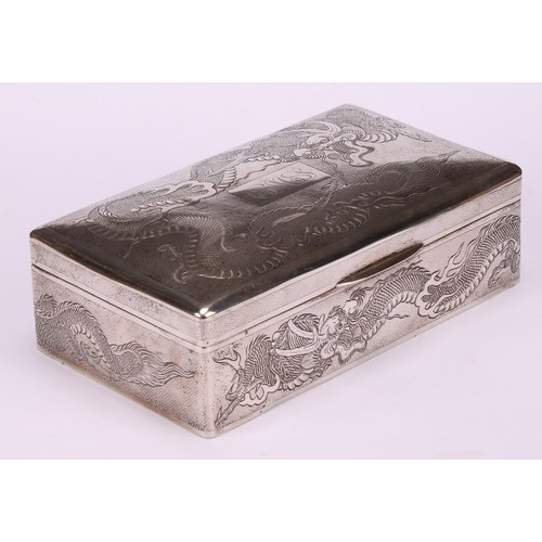 601 - A Chinese silver rectangular cigar box, engraved with dragons on a textured ground, hinged cover, ce... 