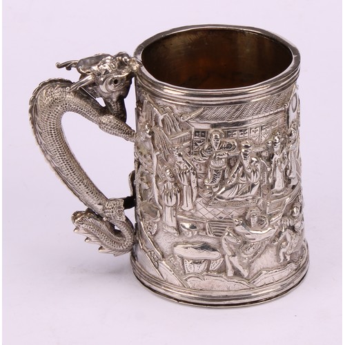 598 - A Chinese export silver mug, double-walled and profusely chased with figures of the court in a lands... 