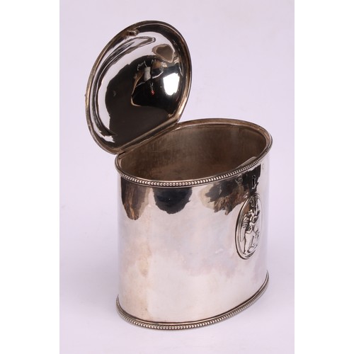 643 - A George III silver oval tea caddy, beaded borders, applied with Neo-Classical oval reserves, hinged... 