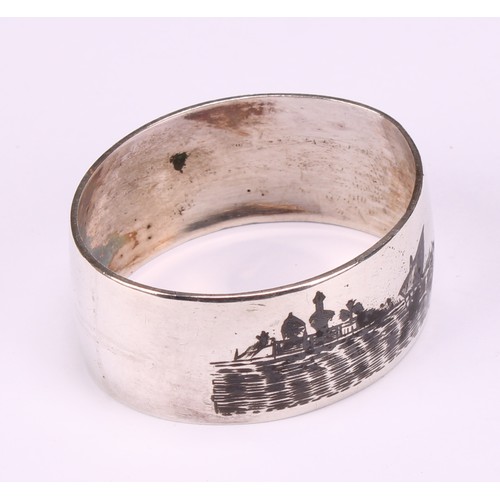 677 - A harlequin suite of four Iraqi silver and niello napkin rings, decorated with genre scenes and land... 