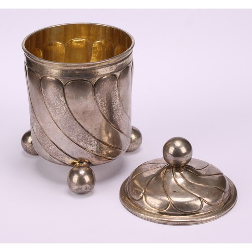 682 - A large 17th century German silver beaker and cover, wrythen fluted, ball finial and feet, gilt inte... 