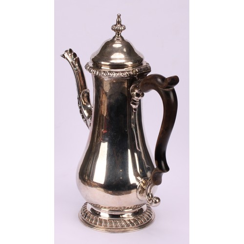 630 - A George III silver baluster coffee pot, hinged domed cover with fluted spire finial, scroll-capped ... 