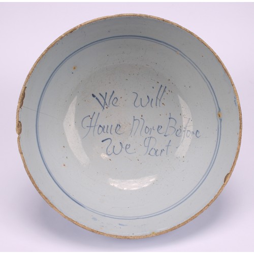 21 - An 18th century English Delft bowl, with motto, We Will Have More Before We Part, the exterior paint... 