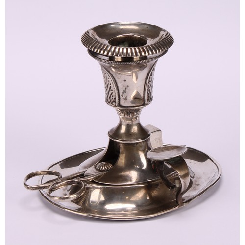 606 - A Continental silver chamber stick, campana sconce applied with palmettes, oval base, snuffers ensui... 