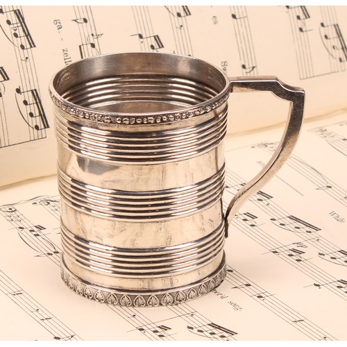 597 - A Chinese China Trade period silver mug, applied rim above three reeded bands, angular scroll handle... 