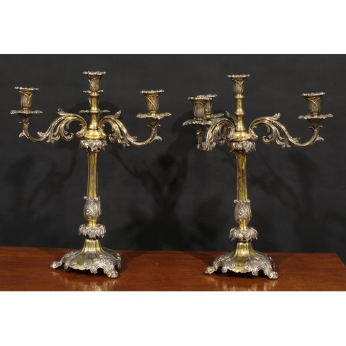 554 - A pair of substantial 19th century electro-plated and parcel-gilt five-light table candelabra, campa... 