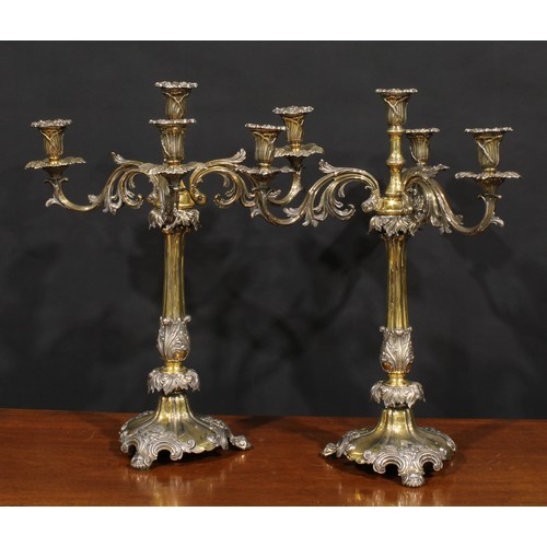 554 - A pair of substantial 19th century electro-plated and parcel-gilt five-light table candelabra, campa... 