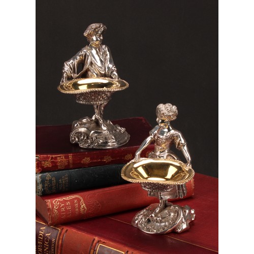 550 - A pair of electroplated sculptural novelty salts, cast as a boy and girl holding baskets, 15cm high