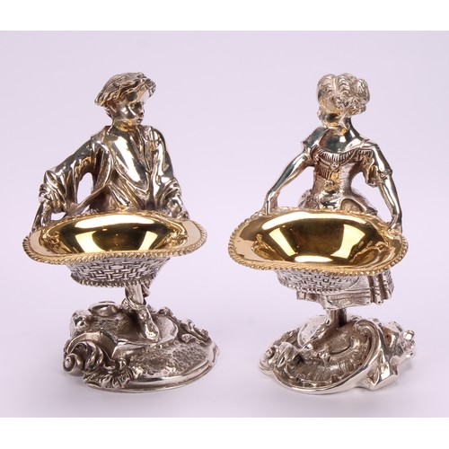 550 - A pair of electroplated sculptural novelty salts, cast as a boy and girl holding baskets, 15cm high