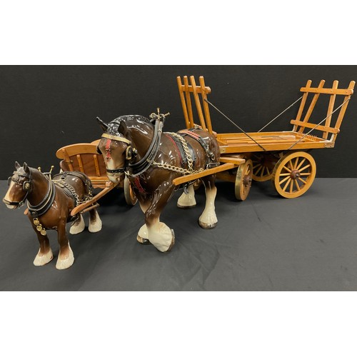 102 - A large Beswick style Shire horse and haycart, another smaller, (2).