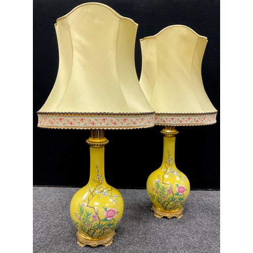 108 - A pair of oviod Chinese style lamps, stylised with blooming blossom on yellow ground, 65cm high (2)