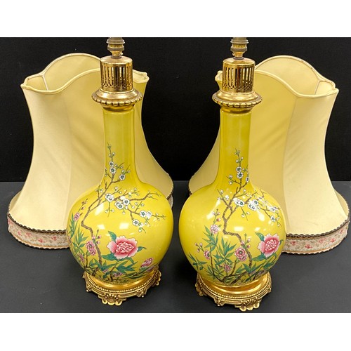 108 - A pair of oviod Chinese style lamps, stylised with blooming blossom on yellow ground, 65cm high (2)