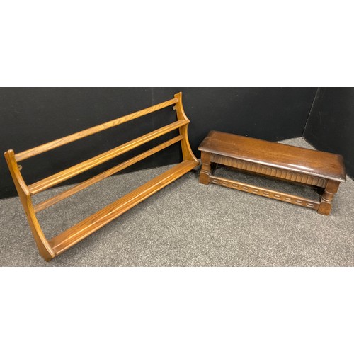 112 - An Ercol stained ash wall mountable plate rack, 49cm high x 107cm wide;  and an Ercol stool, (2).