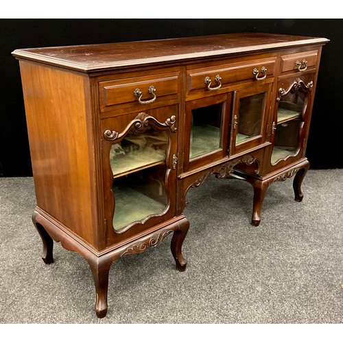 115 - An early 20th century carved mahogany sideboard, three drawers to frieze, above four glazed doors, s... 