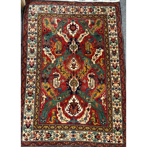 124 - A Persian Caucasan rug, floral field in tones of green, mustard, red, blue and red, approx 234cm x 1... 