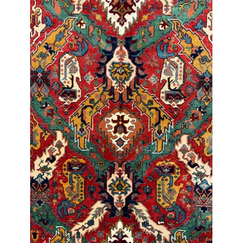 124 - A Persian Caucasan rug, floral field in tones of green, mustard, red, blue and red, approx 234cm x 1... 