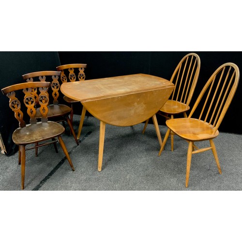 125 - An Ercol elm drop-leaf dining table, oval top, 71.5cm high x 113cm x 124cm wide when extended;  a pa... 