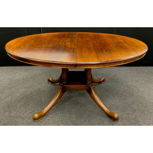 142 - A George III revival oak extending dining table, oval top, pedestal base with four swept cabriole le... 