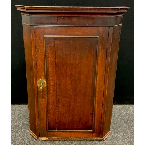 151 - A George III oak corner cupboard, 106.5cm high x 75.5cm wide.