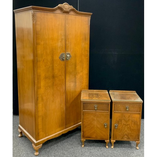 156 - A mid century walnut wardrobe, and pair of bedside cabinets, the wardrobe measuring 192cm high x 95c... 