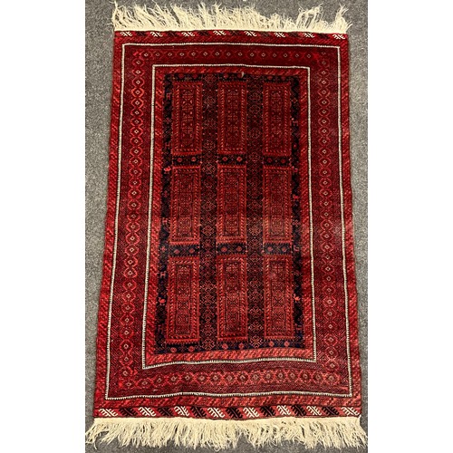 175 - A Persian Balouch rug, with three rows of three rectangular medallions, within three row border, in ... 