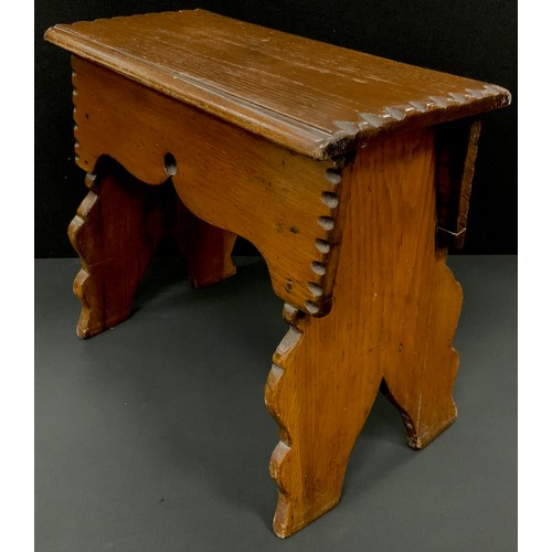 185 - An Arts & Crafts Vernacular boarded oak stool, in the 17th century style, shaped frieze and spreadin... 