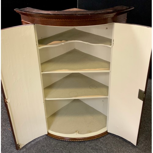 190 - A George III mahogany bow-front corner cupboard, 103cm high x 74cm wide x 53.5cm deep.