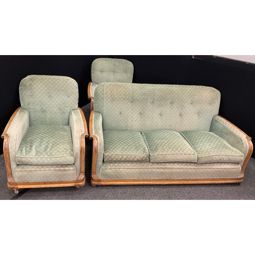 200 - An early to mid century three seat sofa and pair of armchairs, carved walnut frames, the sofa measur... 