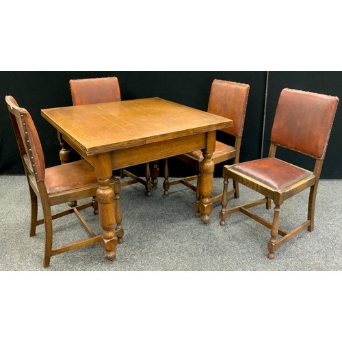 203 - An oak dining suite, comprised of drawleaf table, and set of four dining chairs, with tan leather ba... 