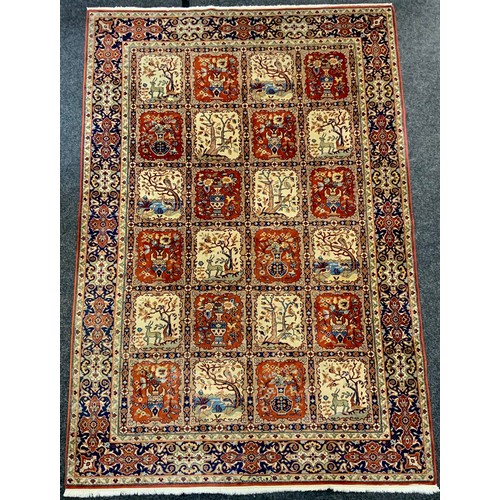 212 - A Persian Qom/Moud style Garden carpet, with central field of twenty four panels of animals, flowers... 