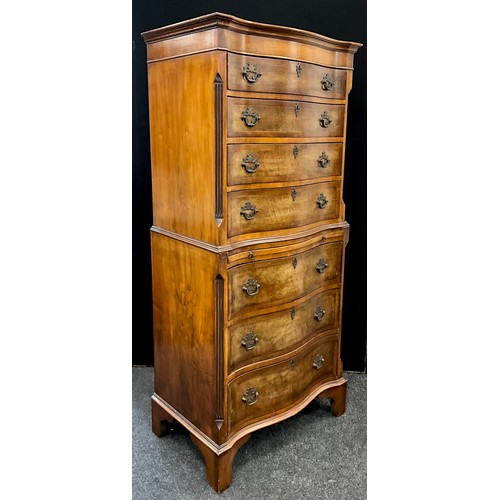 215 - A George III revival walnut cross-banded mahogany chest on chest, of small proportions. Serpentine-s... 