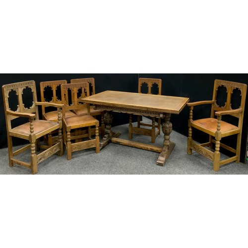 228 - An early to mid 20th century carved oak gothic revival dining suite, possibly early Titchmarsh and G... 