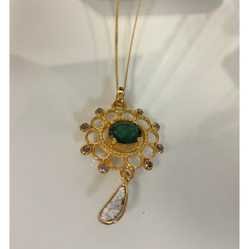 287 - A Fancy emerald and diamond pendant in yellow metal set with oval emerald, rose-cut diamonds and a s... 