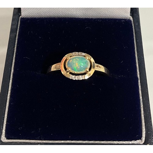 291 - A 9ct yellow gold oval cabochon opal and Round brilliant cut diamond ring,size P 1.8g gross, boxed