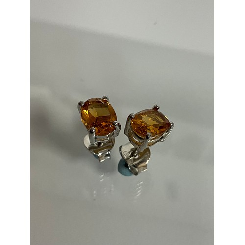 293 - A Pair of citrine stud earrings in silver mounts,