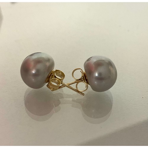 296 - A Pair of 9ct yellow gold studs set with spheroid grey cultured pearls, boxed